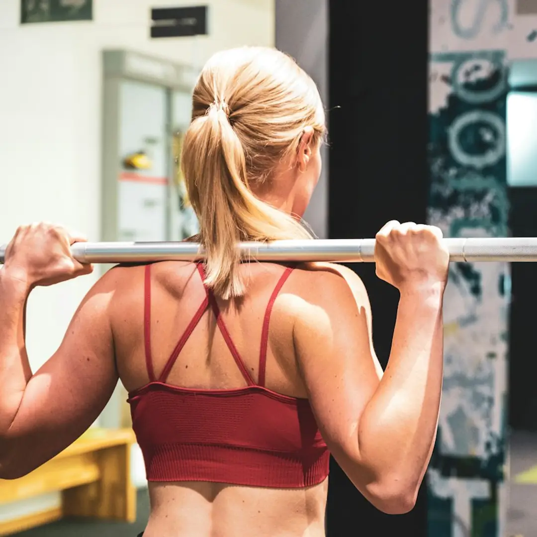 Woman lifting a barbell in a gym