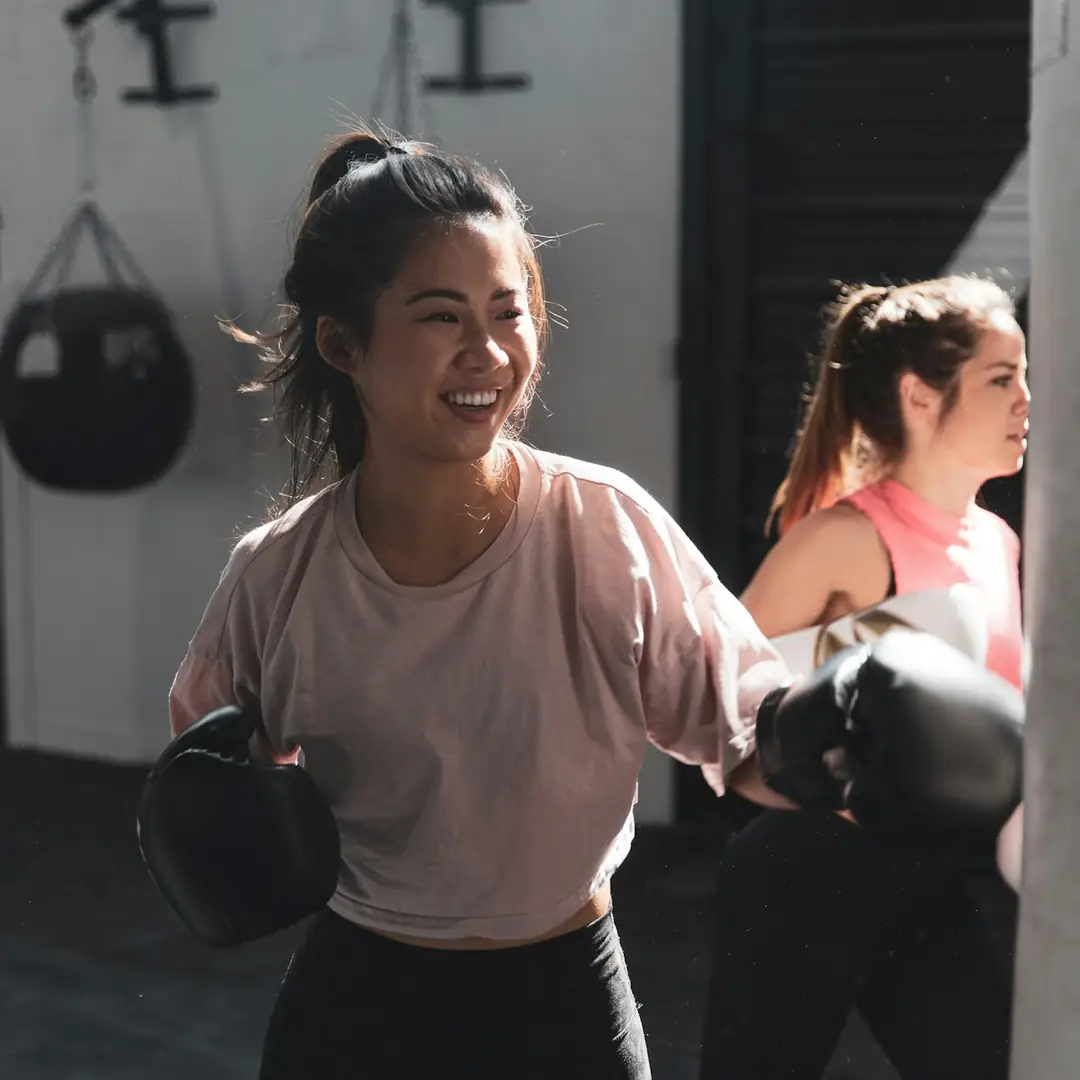 Women laughing during a boxing workout