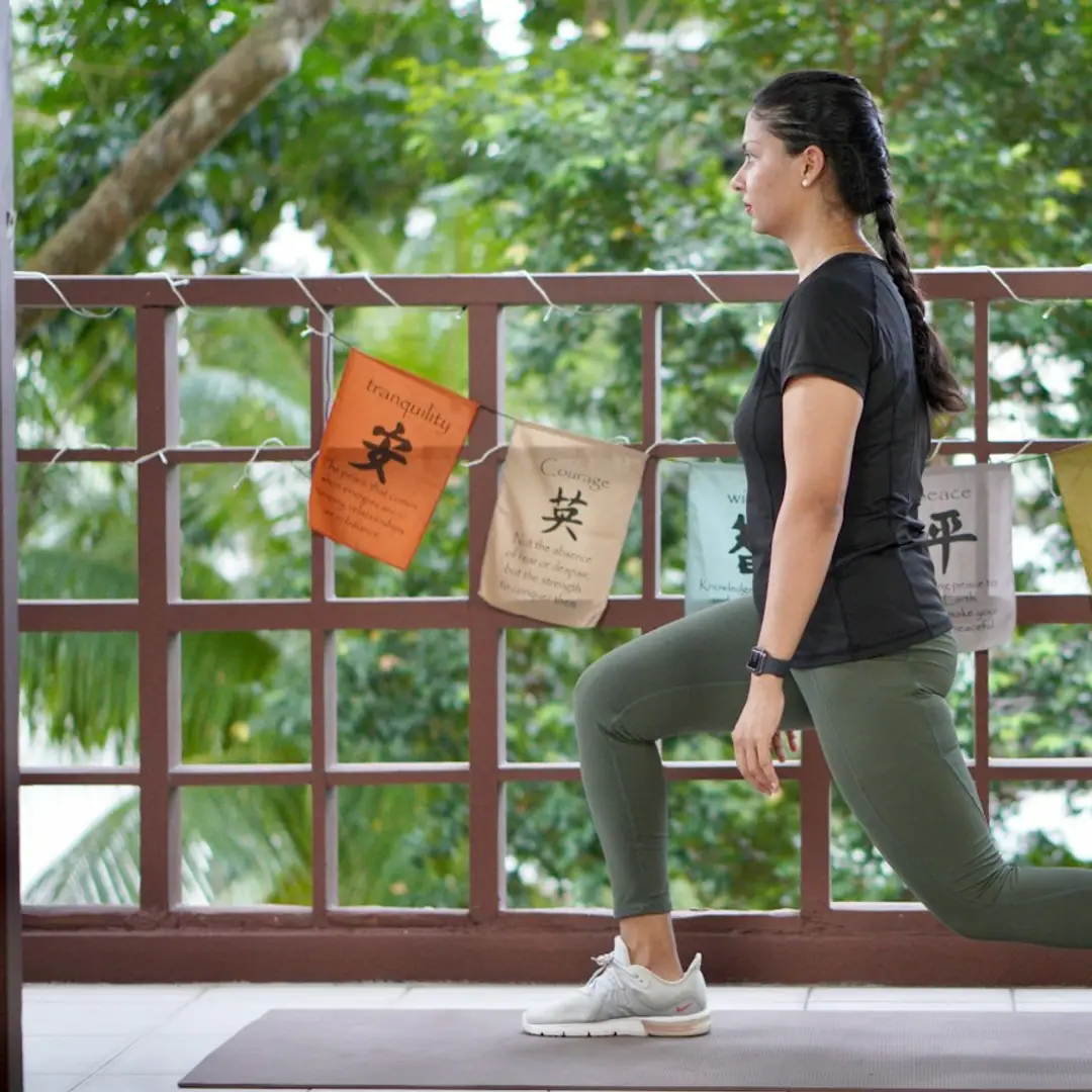 Woman doing a lunge stretch outdoors
