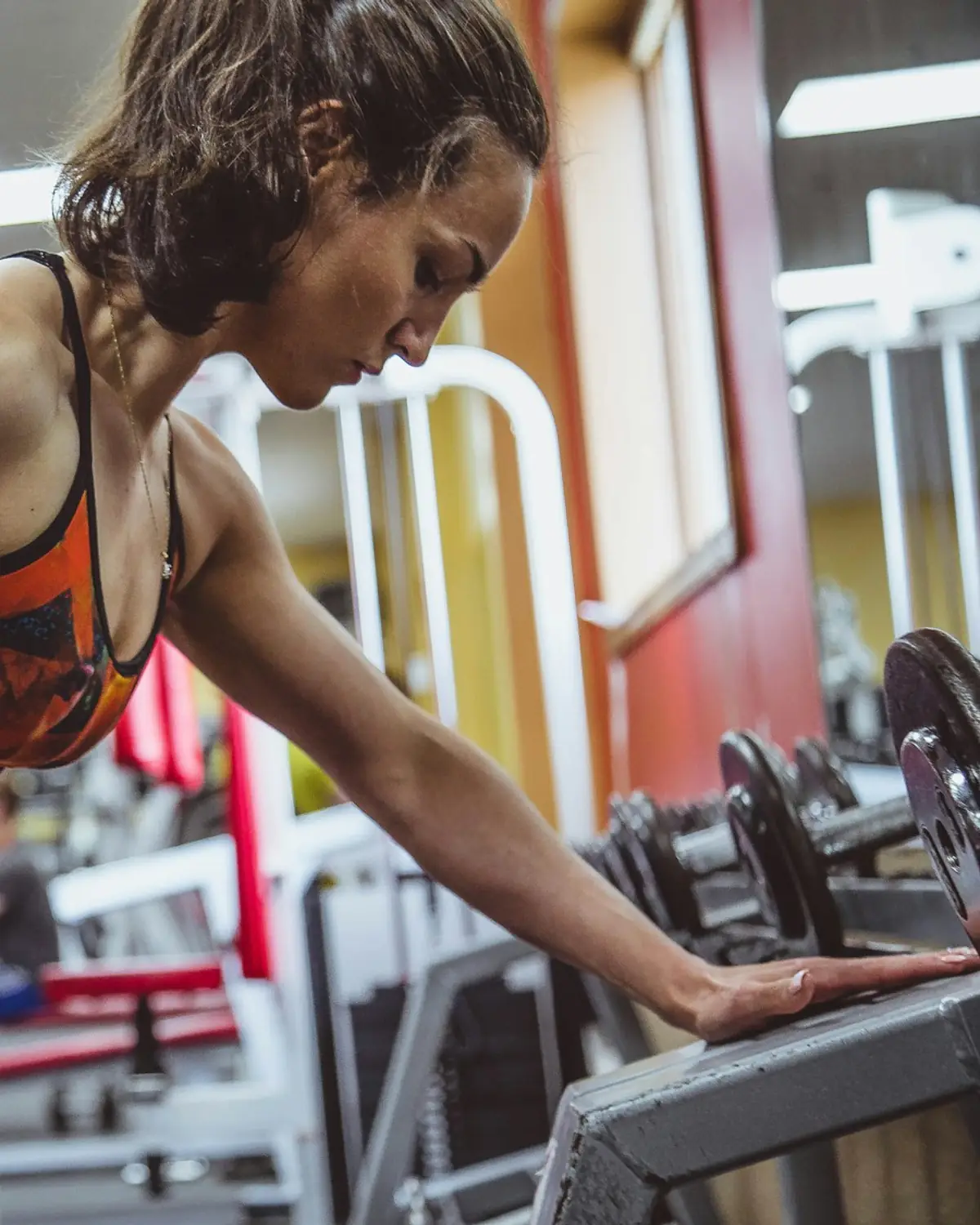 Woman performing a barbell lift with focus